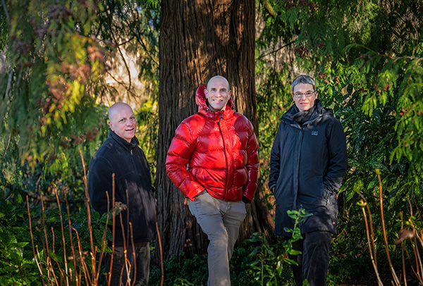 Drs. Michael Brauer, Chris Carlsten and Sarah Henderson standing in front of a tree