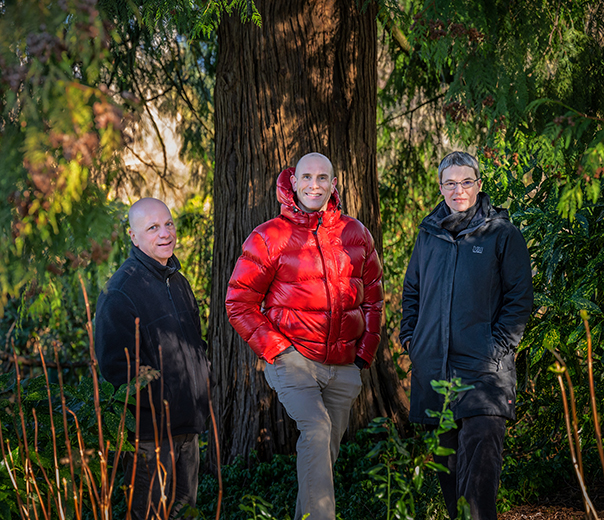Drs. Michael Brauer, Chris Carlsten and Sarah Henderson standing in front of a tree